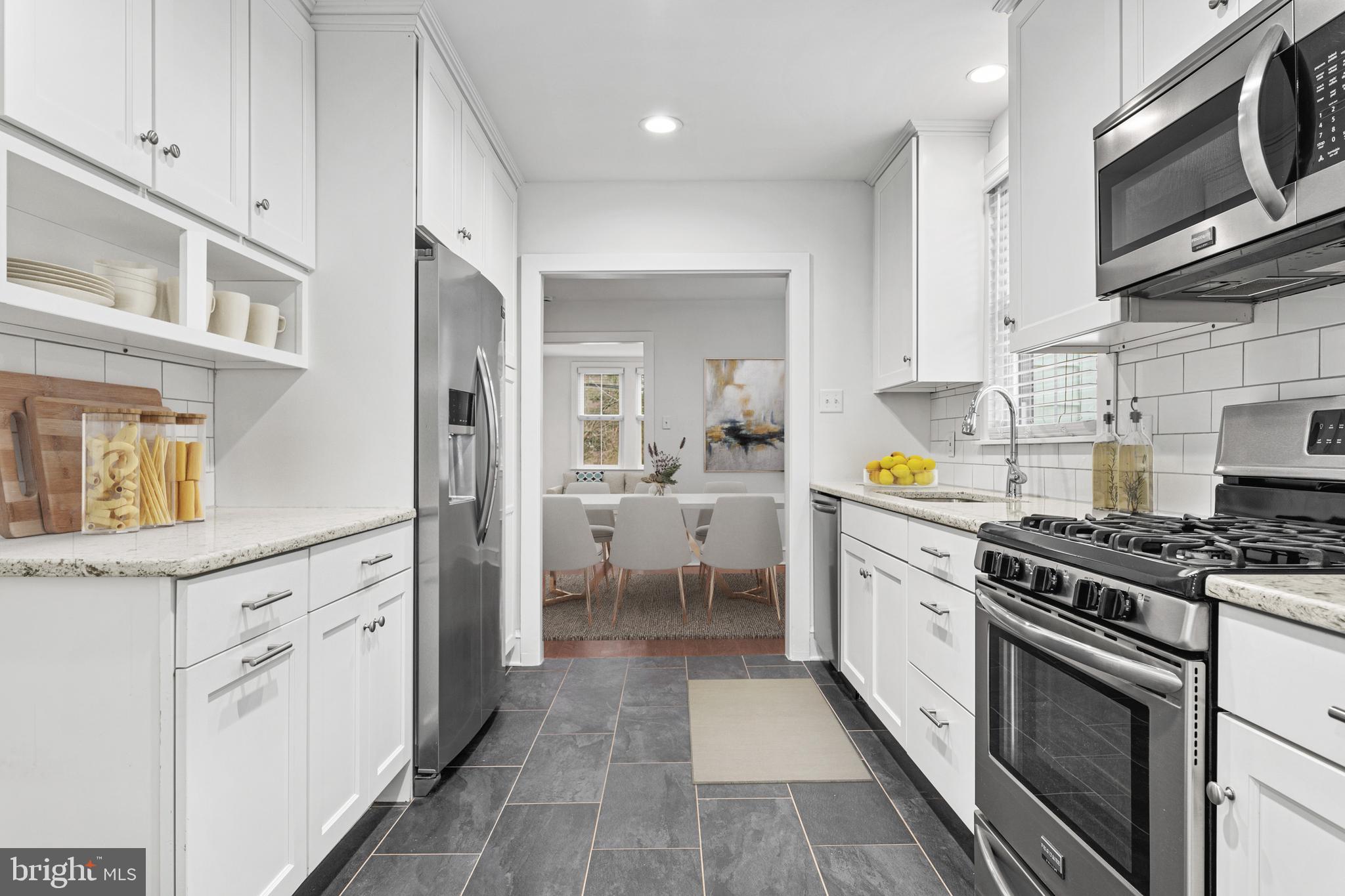 312 South Devon Avenue Wayne, PA 19087 - Photo 14 of 38 a kitchen with stainless steel appliances granite countertop a stove and a sink
