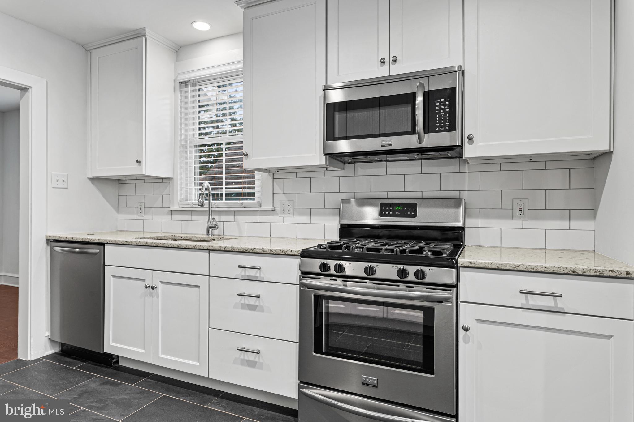 312 South Devon Avenue Wayne, PA 19087 - Photo 15 of 38 a kitchen with granite countertop white cabinets and appliances