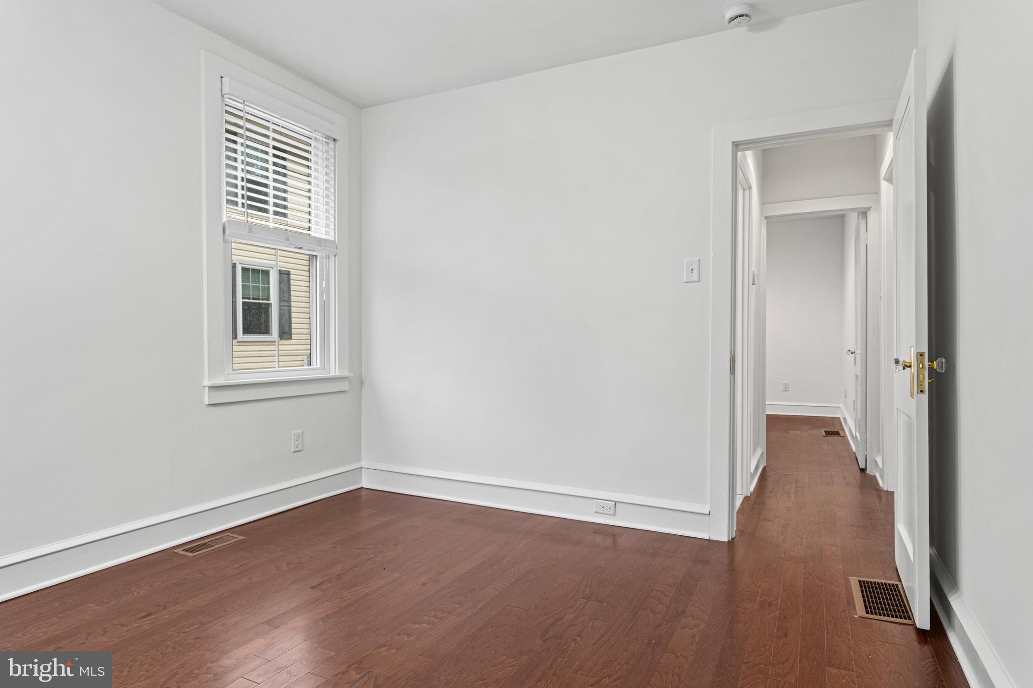 312 South Devon Avenue Wayne, PA 19087 - Photo 21 of 38 an empty room with wooden floor and windows