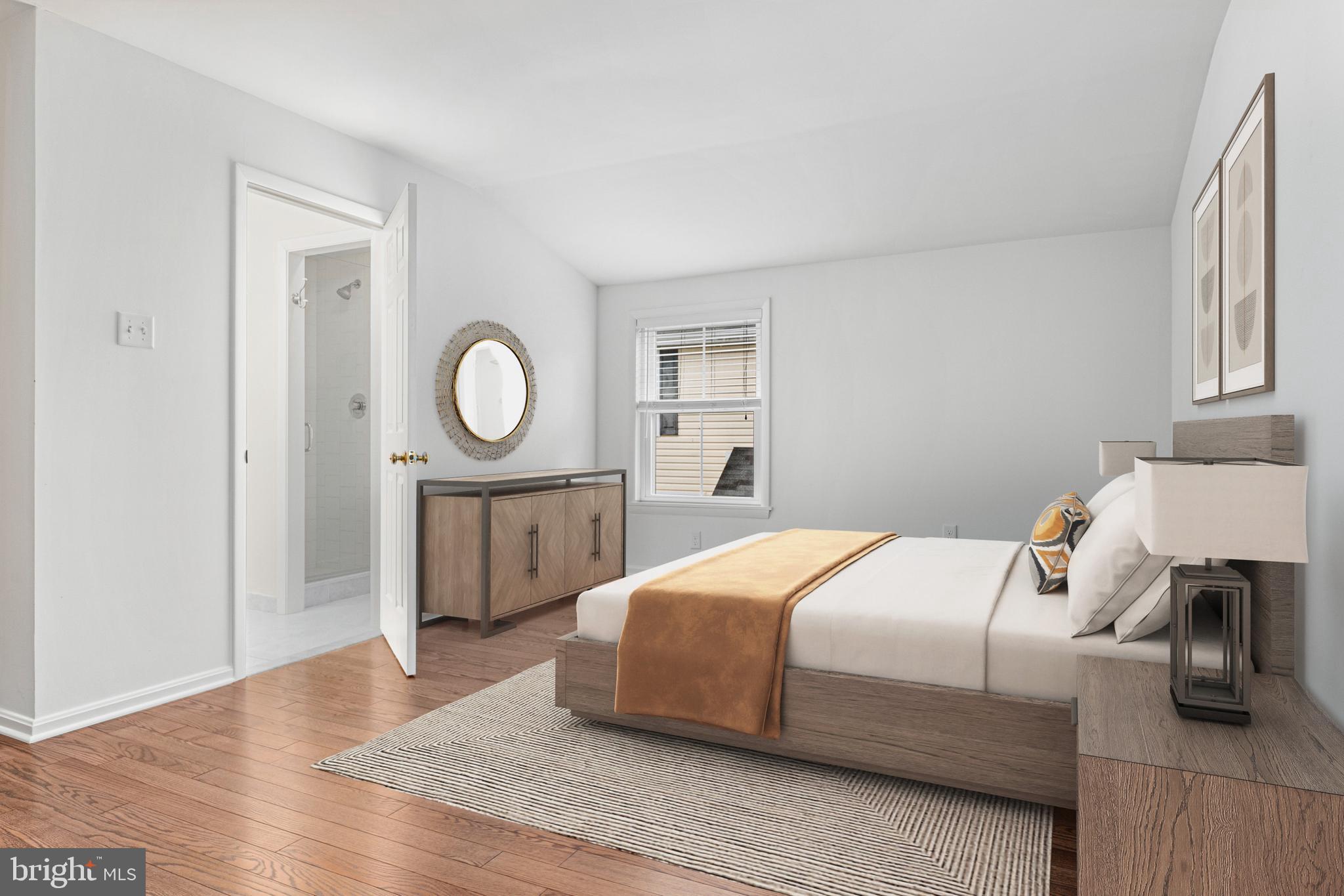 312 South Devon Avenue Wayne, PA 19087 - Photo 34 of 38 a bedroom with a bed a mirror and a lamp on dresser