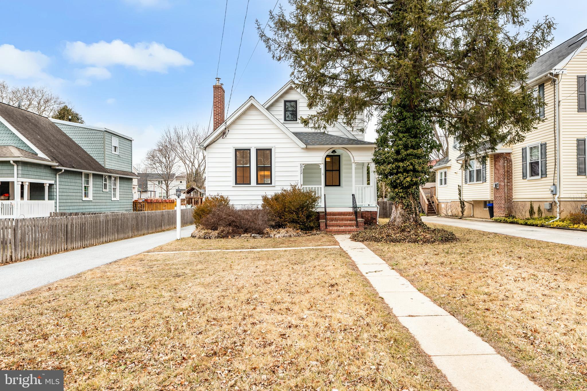 312 South Devon Avenue Wayne, PA 19087 - Photo 4 of 38 a front view of a house with a yard