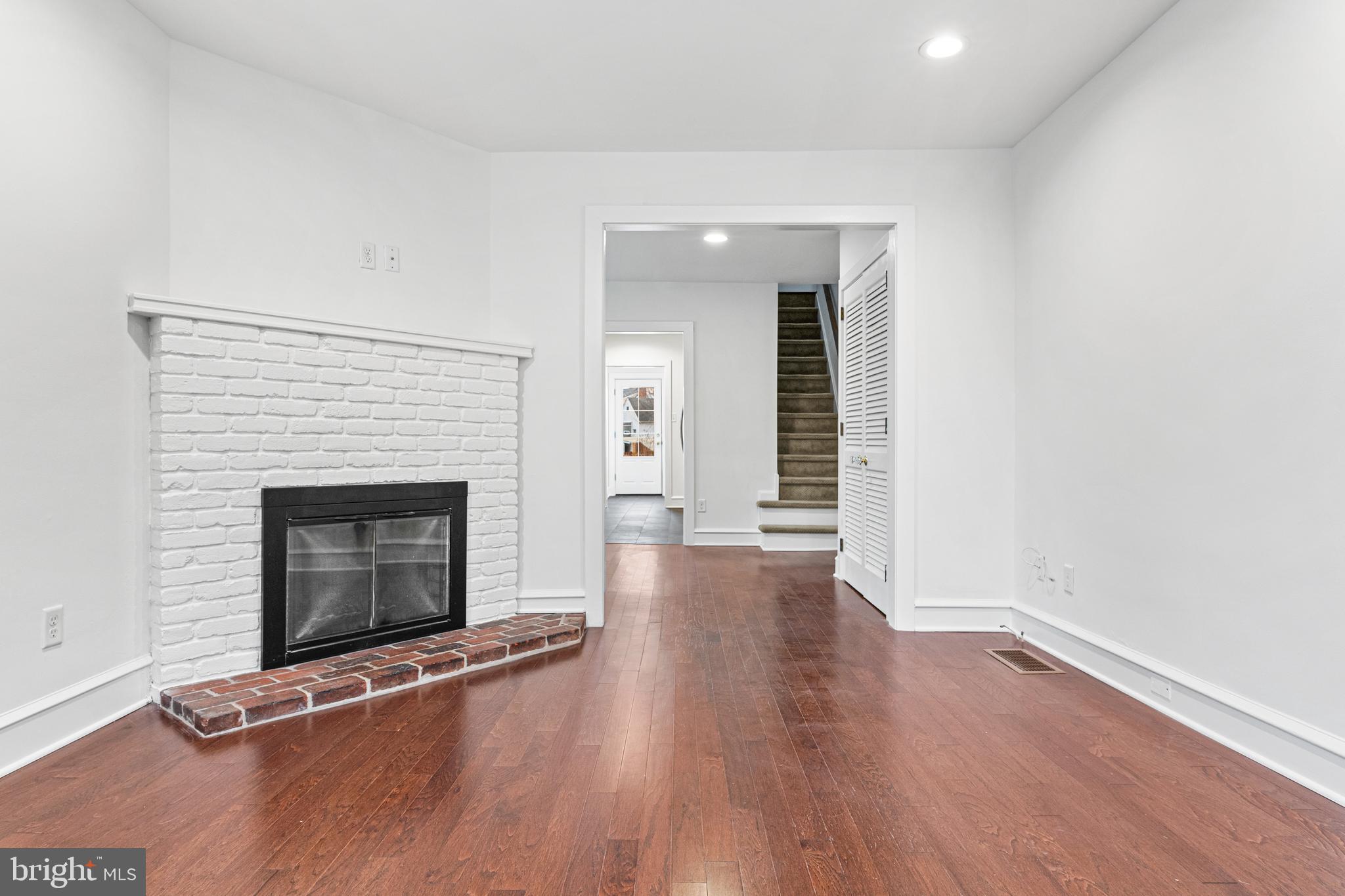 312 South Devon Avenue Wayne, PA 19087 - Photo 5 of 38 an empty room with wooden floor and fireplace