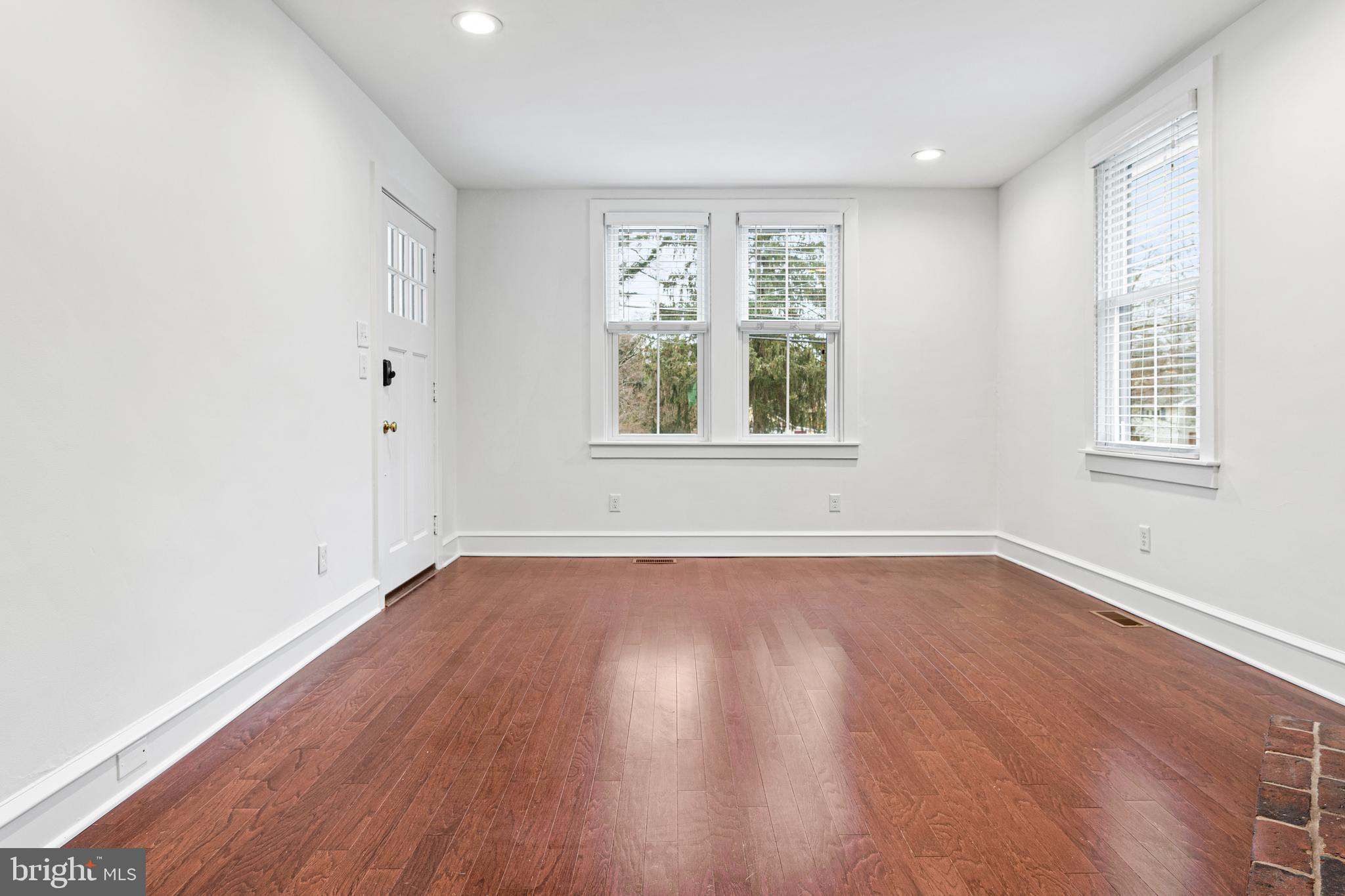 312 South Devon Avenue Wayne, PA 19087 - Photo 7 of 38 an empty room with wooden floor and windows