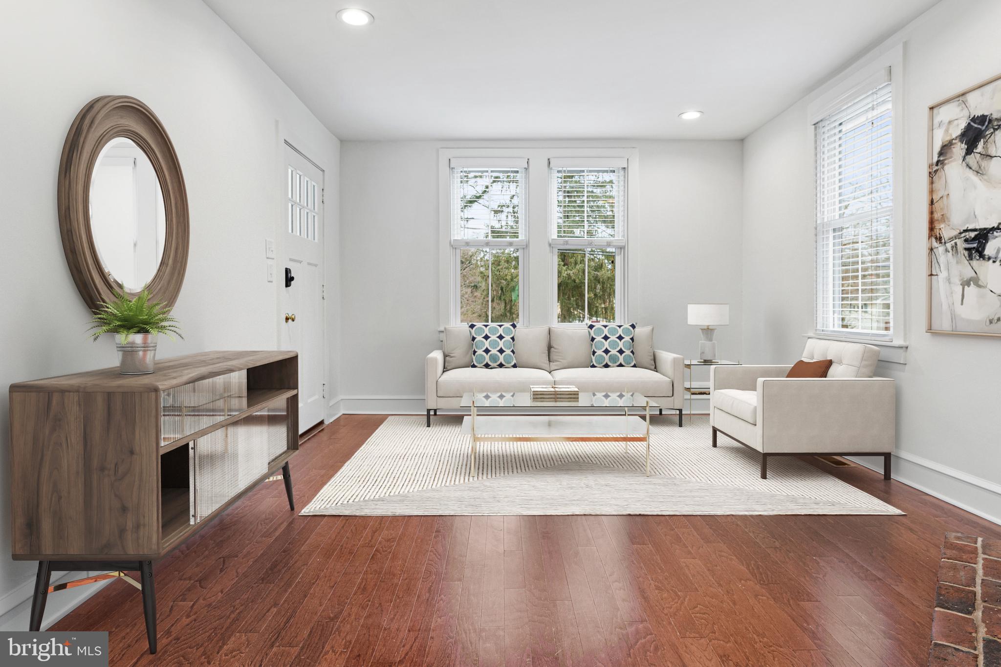 312 South Devon Avenue Wayne, PA 19087 - Photo 8 of 38 a living room with furniture a fireplace and a large window