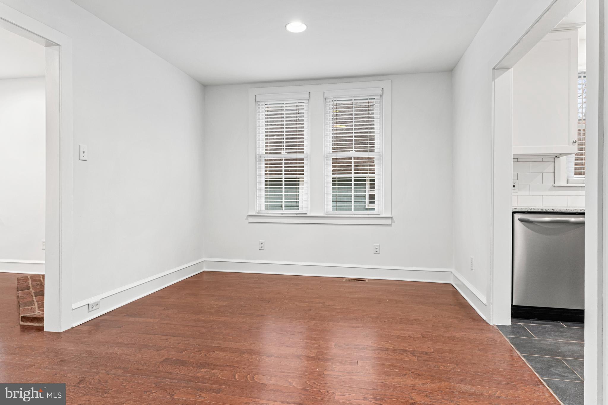 312 South Devon Avenue Wayne, PA 19087 - Photo 9 of 38 an empty room with wooden floor and windows