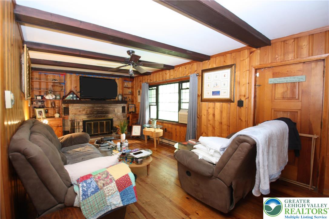 305 Cedar Hill Road Effort, PA 18330 - Photo 10 of 20 a living room with furniture a fireplace and a flat screen tv