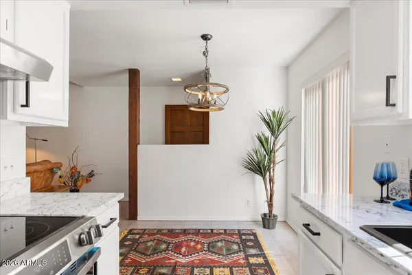 a kitchen with a potted plant on the counter and cabinets