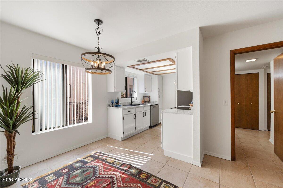 65 Verde Valley School Road, Unit H10 Sedona, AZ 86351 - Photo 7 of 20 a kitchen that has a lot of white cabinets and stainless steel appliances