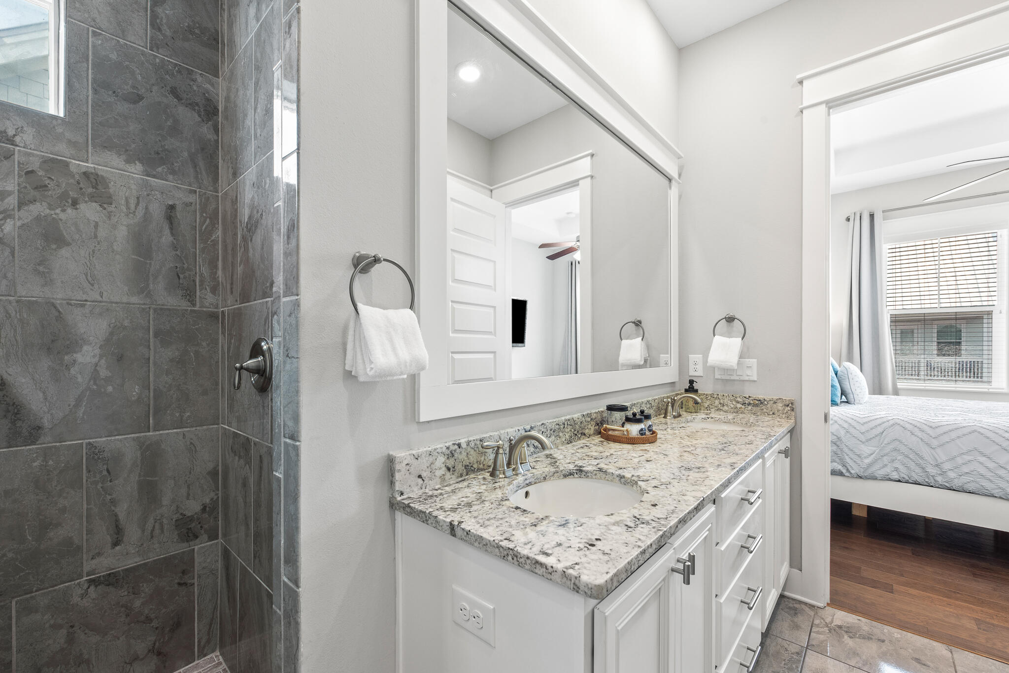 26 Milestone Dr Inlet Beach, Unit C Inlet Beach, FL 32461 - Photo 19 of 36 a bathroom with a granite countertop sink and a mirror