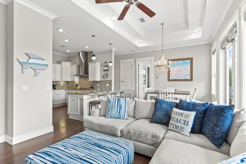 a living room with furniture and a chandelier