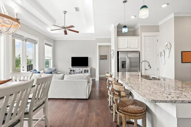 a living room with furniture a fireplace and a chandelier