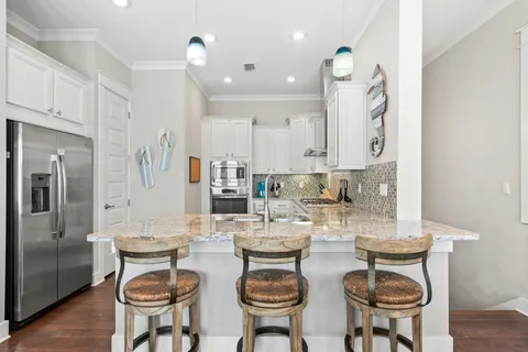 a view of a dining room with furniture and a chandelier