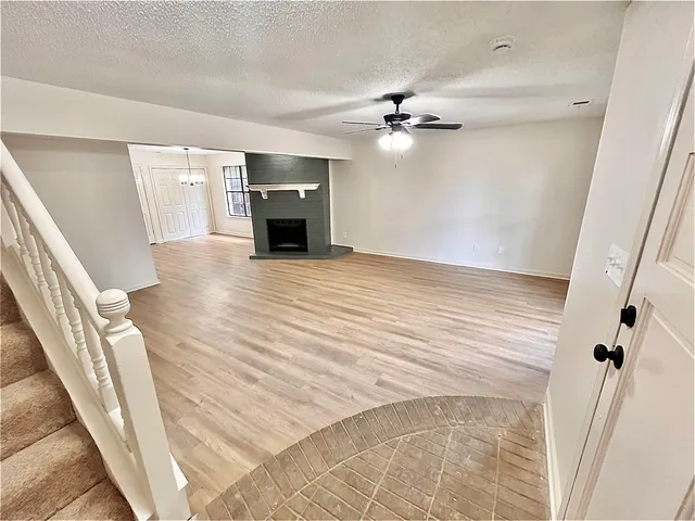 wooden floor in an empty room with a fireplace