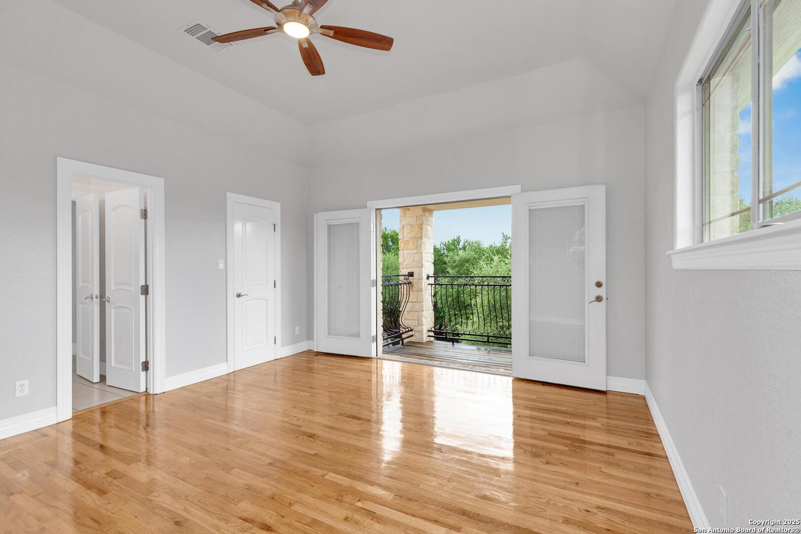 1130 Whispering Water Spring Branch, TX 78070 - Photo 20 of 43 a view of an empty room with wooden floor and a window
