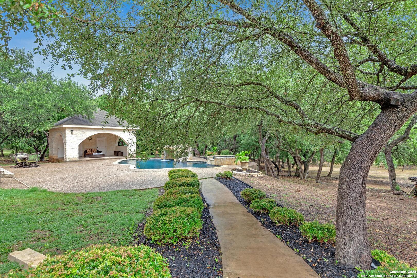 1130 Whispering Water Spring Branch, TX 78070 - Photo 27 of 43 a front view of a house with a yard and trees