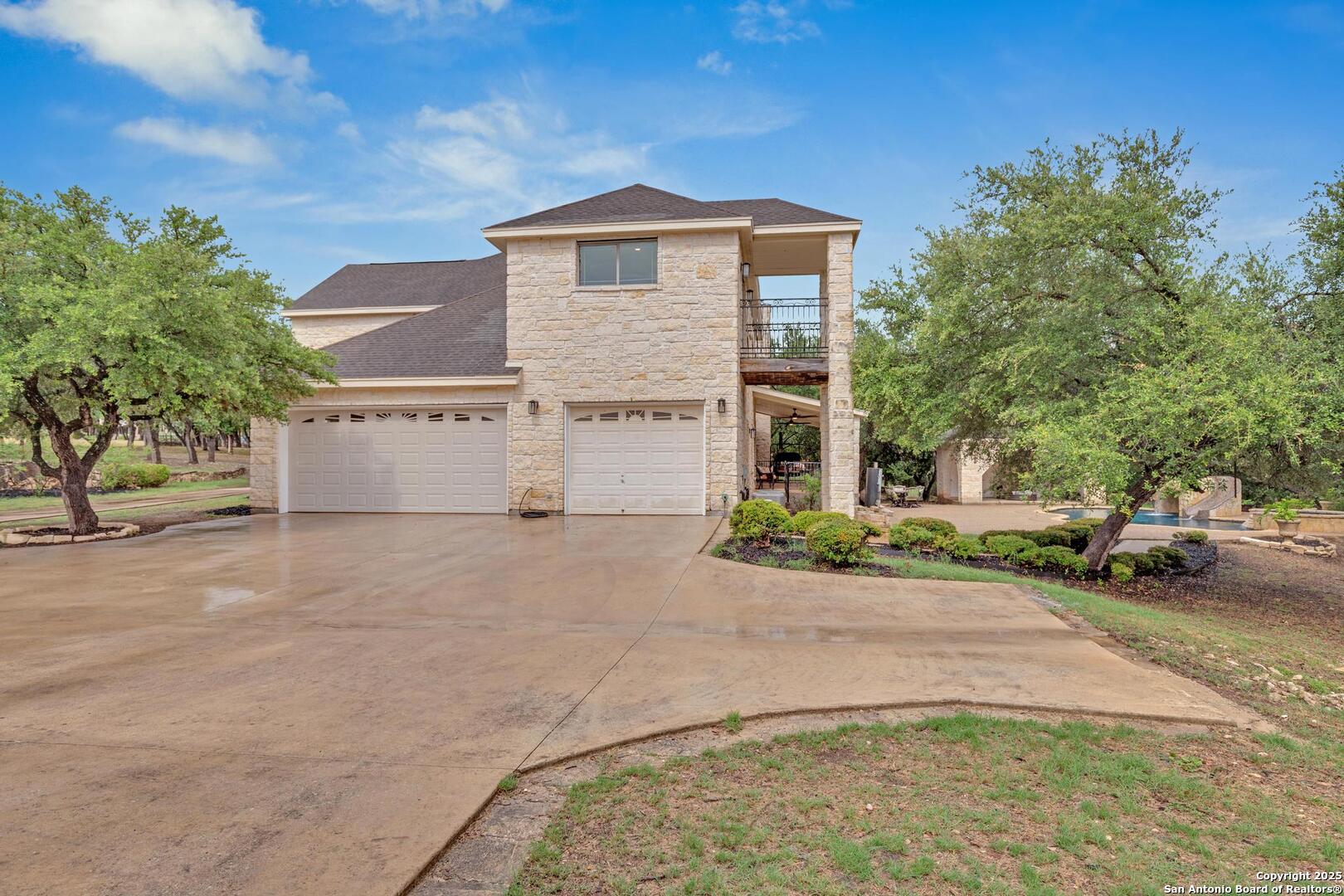 1130 Whispering Water Spring Branch, TX 78070 - Photo 29 of 43 a front view of a house with a yard and garage