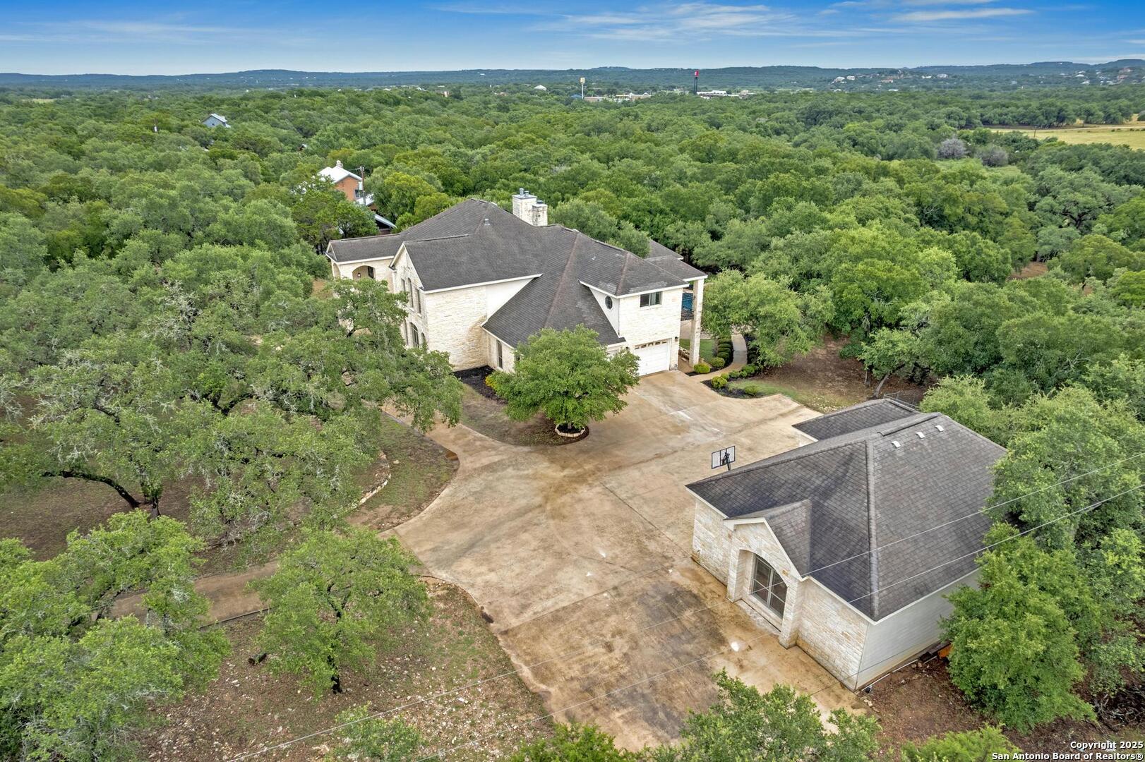 1130 Whispering Water Spring Branch, TX 78070 - Photo 32 of 43 an aerial view of a house with a yard