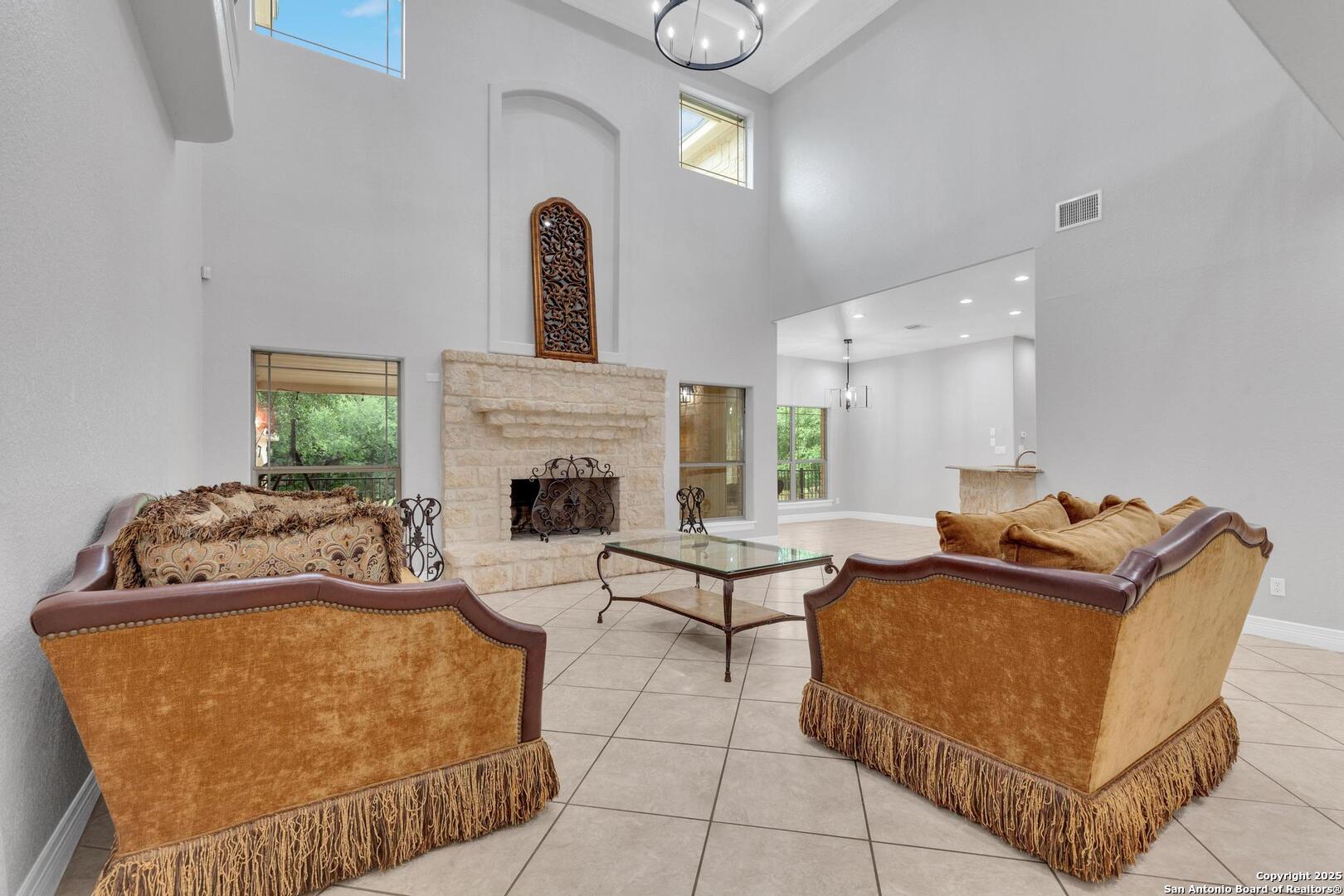 1130 Whispering Water Spring Branch, TX 78070 - Photo 4 of 43 a living room with furniture a fireplace and a potted plant
