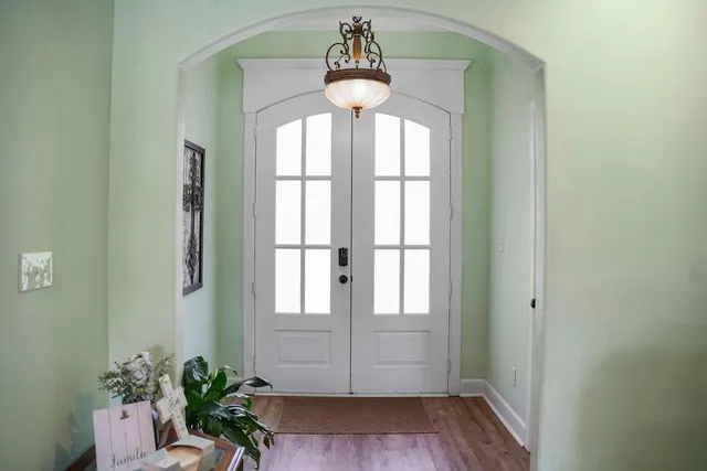 a front view of a house with a window and wooden floor