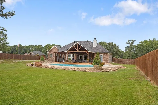 a outdoor living space with patio furniture and a fireplace