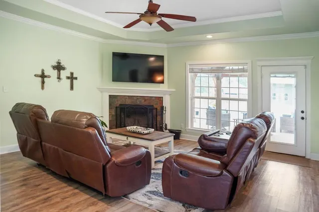 a living room with furniture a flat screen tv and a fireplace