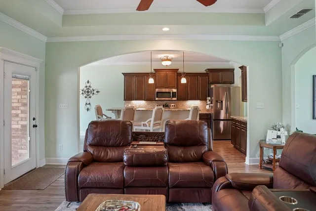 a living room with furniture and a chandelier