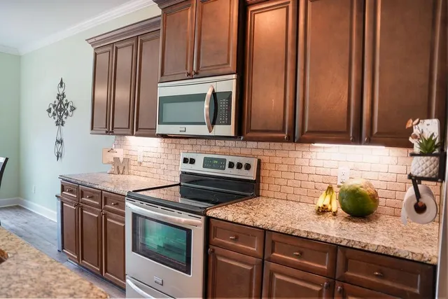 a kitchen with appliances cabinets and a counter top space