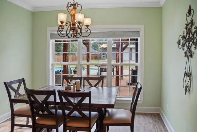 a view of a dining room with furniture and chandelier