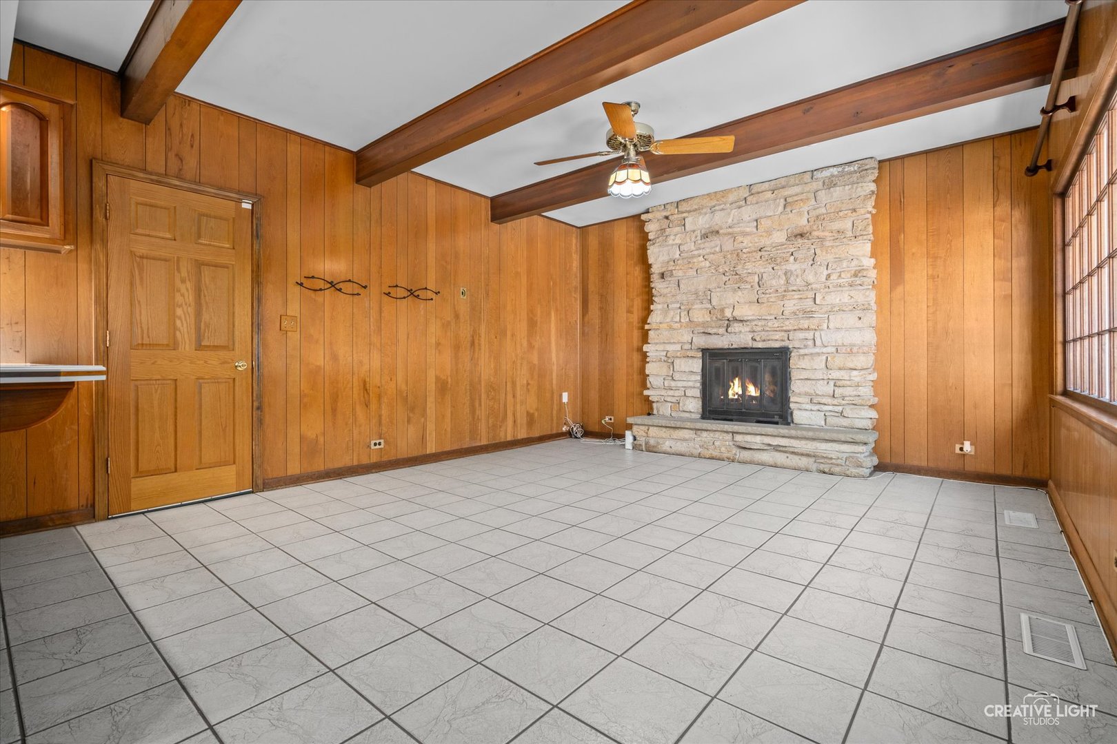 1800 East Algonquin Road Des Plaines, IL 60016 - Photo 11 of 26 a view of an empty room with a fireplace and a window