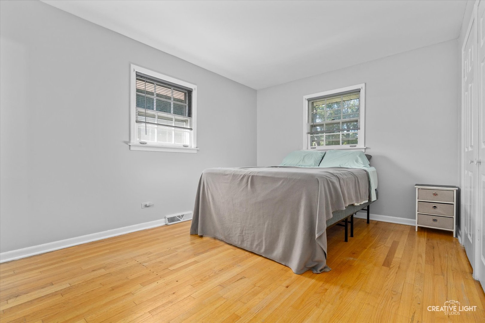 1800 East Algonquin Road Des Plaines, IL 60016 - Photo 16 of 26 a bedroom with a bed and wooden floor