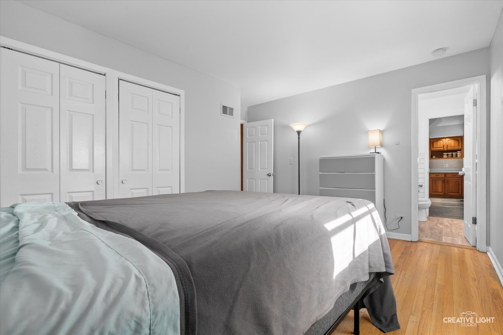 1800 East Algonquin Road Des Plaines, IL 60016 - Photo 17 of 26 a bed room with a bed and a mirror