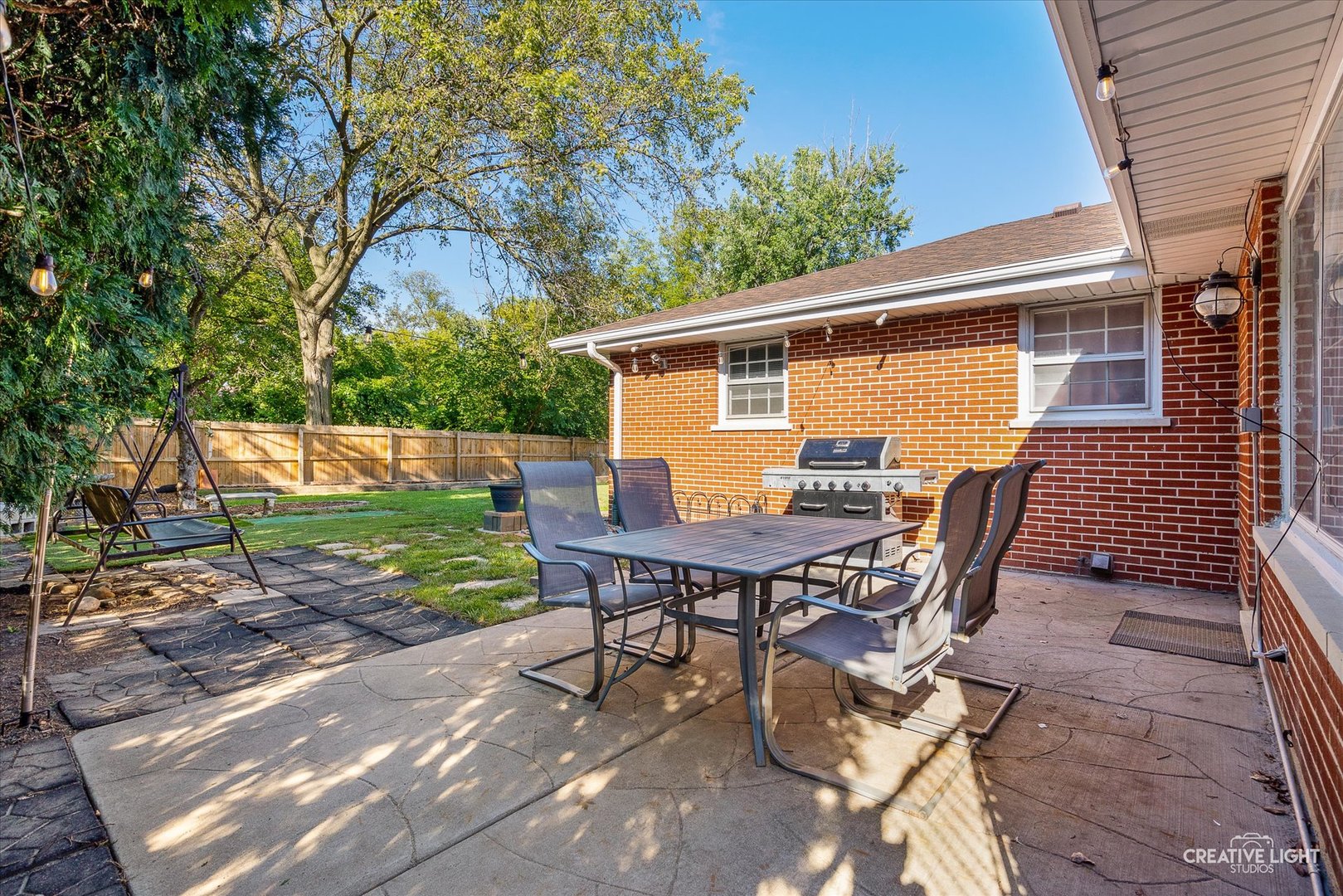 1800 East Algonquin Road Des Plaines, IL 60016 - Photo 23 of 26 a view of backyard with table and chairs and wooden fence
