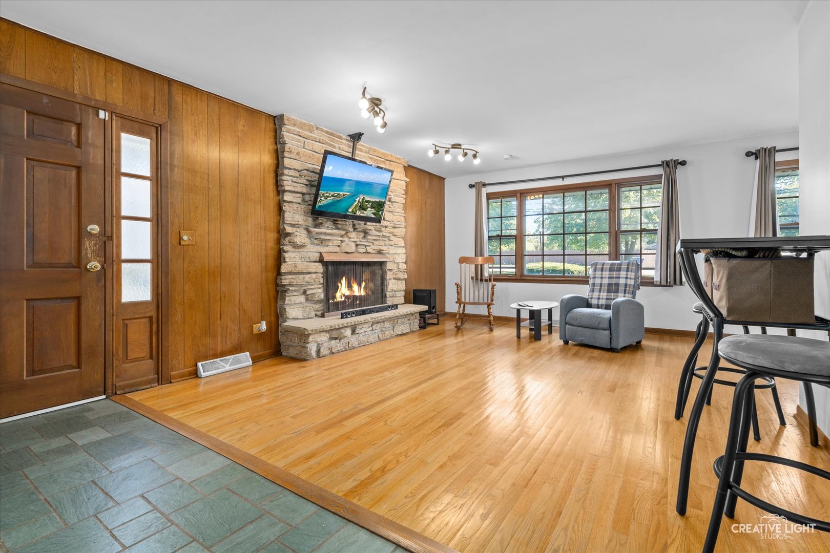 1800 East Algonquin Road Des Plaines, IL 60016 - Photo 4 of 26 a living room with furniture pool table wooden floor and a fireplace