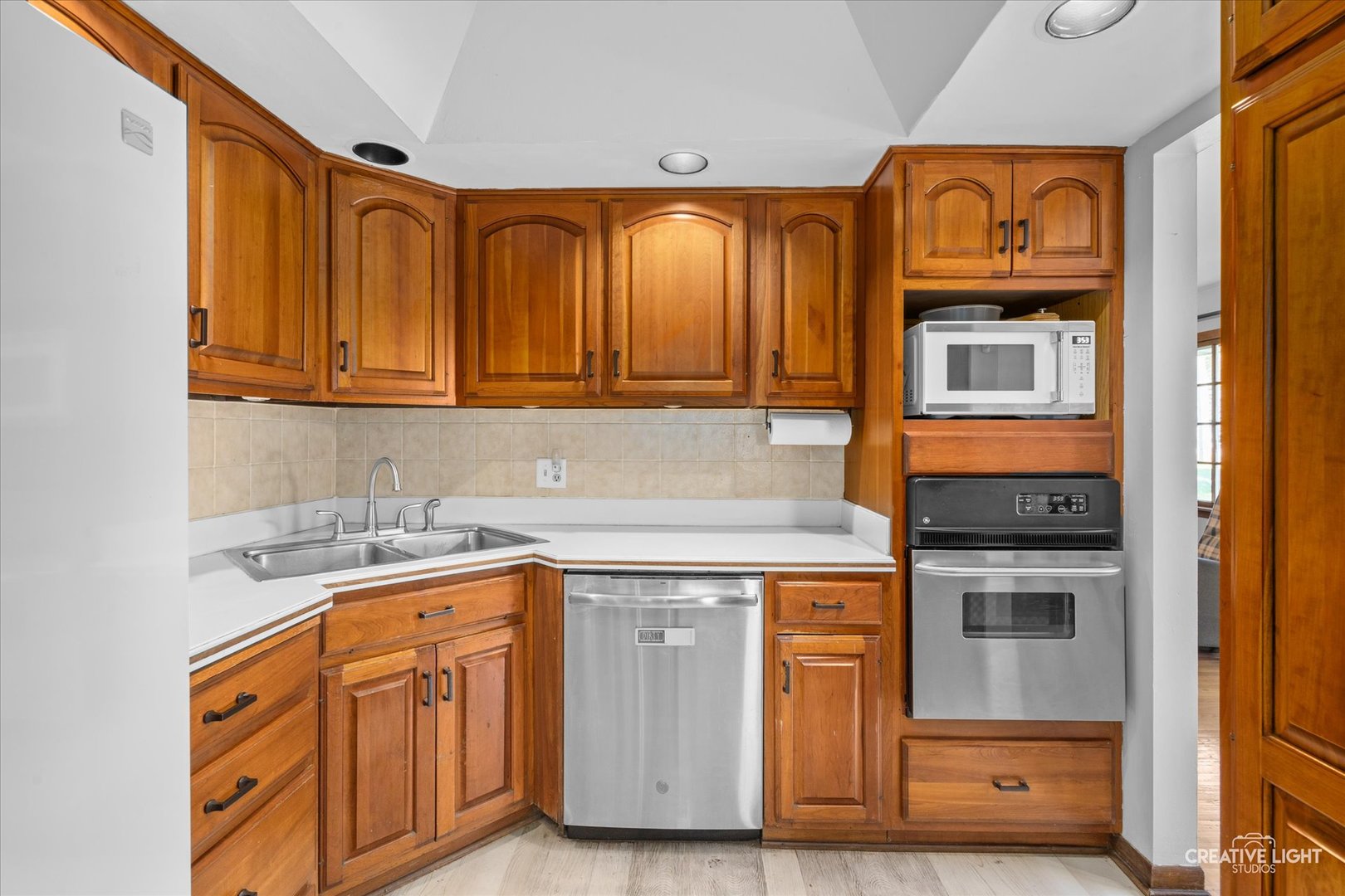 1800 East Algonquin Road Des Plaines, IL 60016 - Photo 9 of 26 a kitchen with stainless steel appliances granite countertop a stove and cabinets