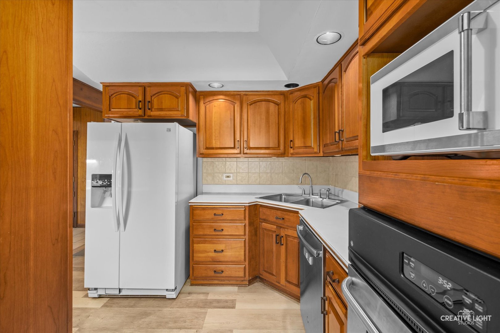 1800 East Algonquin Road Des Plaines, IL 60016 - Photo 10 of 26 a kitchen with stainless steel appliances granite countertop a refrigerator and a stove top oven