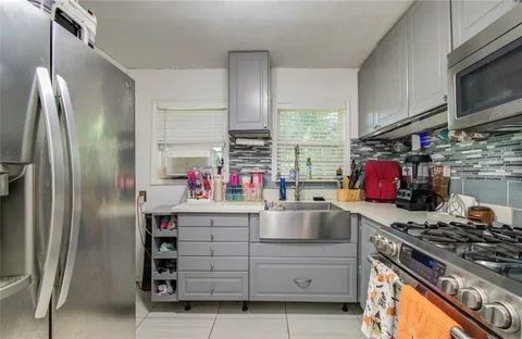 a kitchen with stainless steel appliances granite countertop a stove and a refrigerator