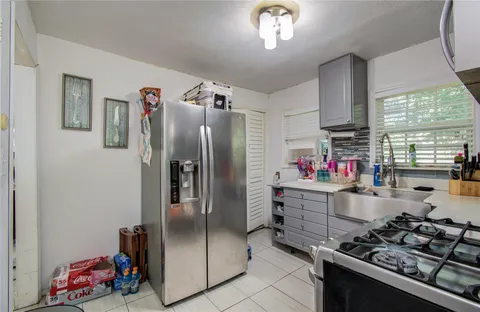 a kitchen with stainless steel appliances granite countertop a refrigerator and a stove
