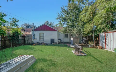 a view of a backyard with table and chairs and a fire pit