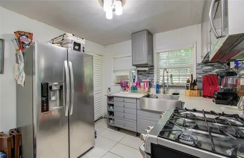 a kitchen with stainless steel appliances granite countertop a refrigerator and a stove