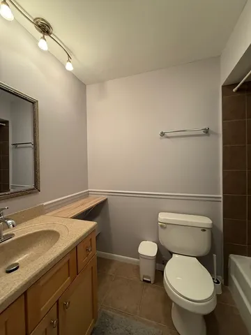 a bathroom with a sink a toilet and vanity