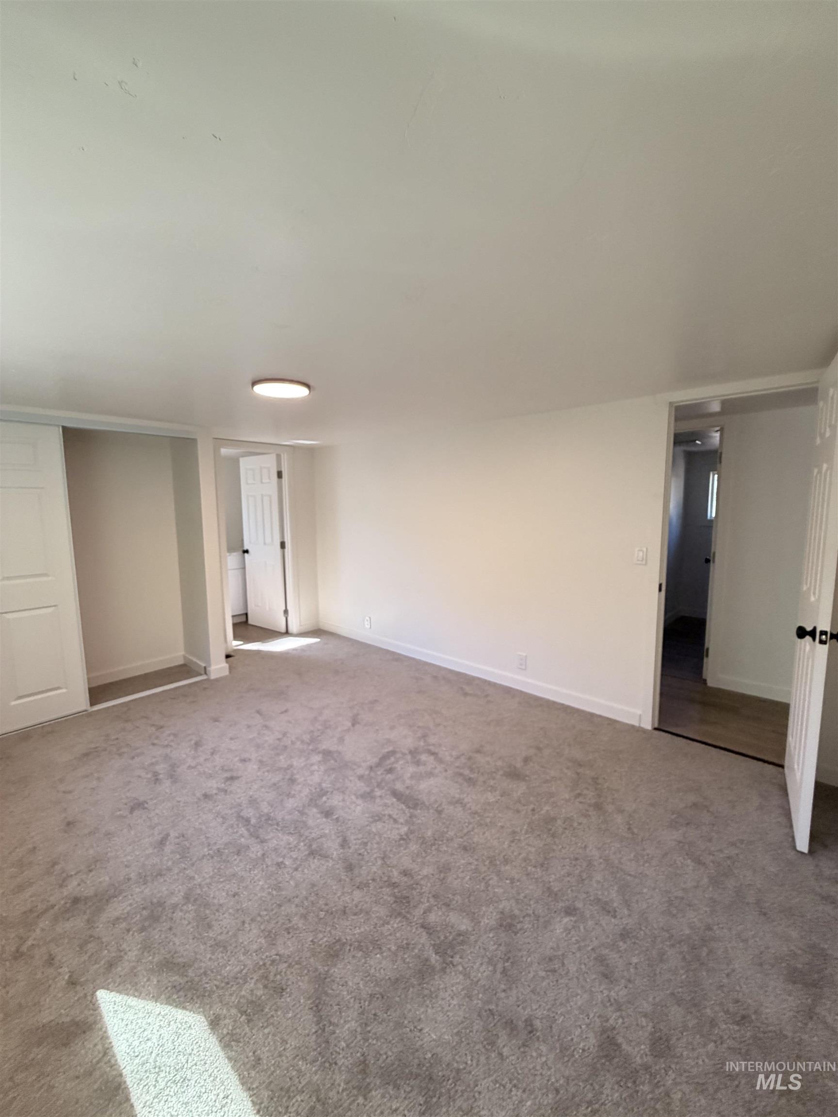 151 View Road Kamiah, ID 83536 - Photo 19 of 49 Spacious room featuring gray carpet flooring, white painted walls, and white trim