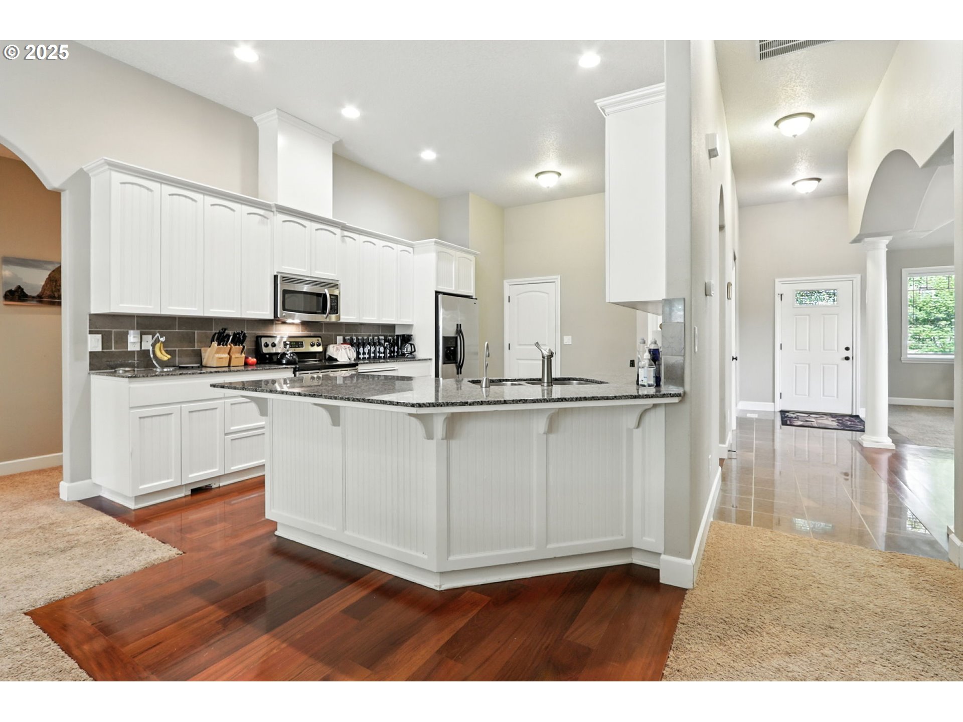 207 Finneys Avenue Molalla, OR 97038 - Photo 5 of 24 a kitchen with kitchen island granite countertop a sink cabinets and stainless steel appliances