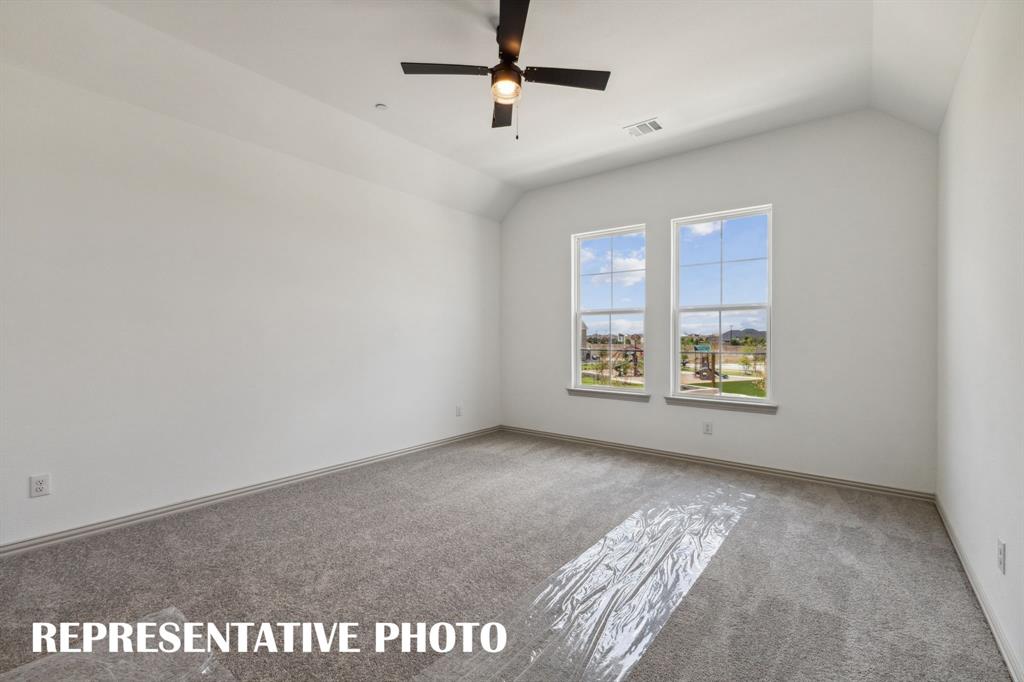 1009 Splitrock Drive Allen, TX 75013 - Photo 10 of 20 an empty room with windows and ceiling fan