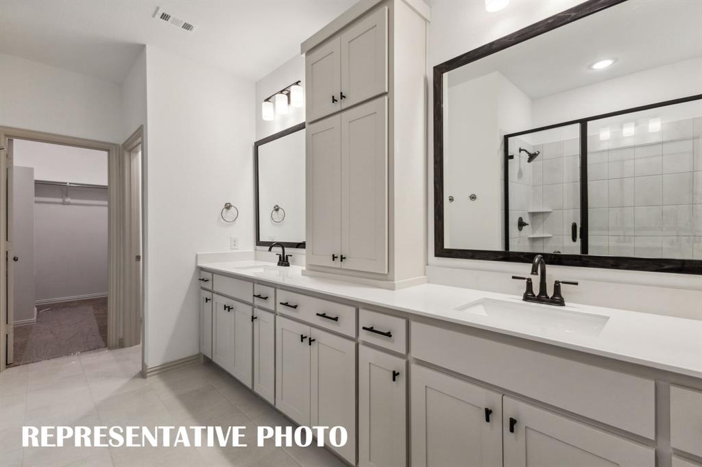 1009 Splitrock Drive Allen, TX 75013 - Photo 11 of 20 a bathroom with a sink and a mirror