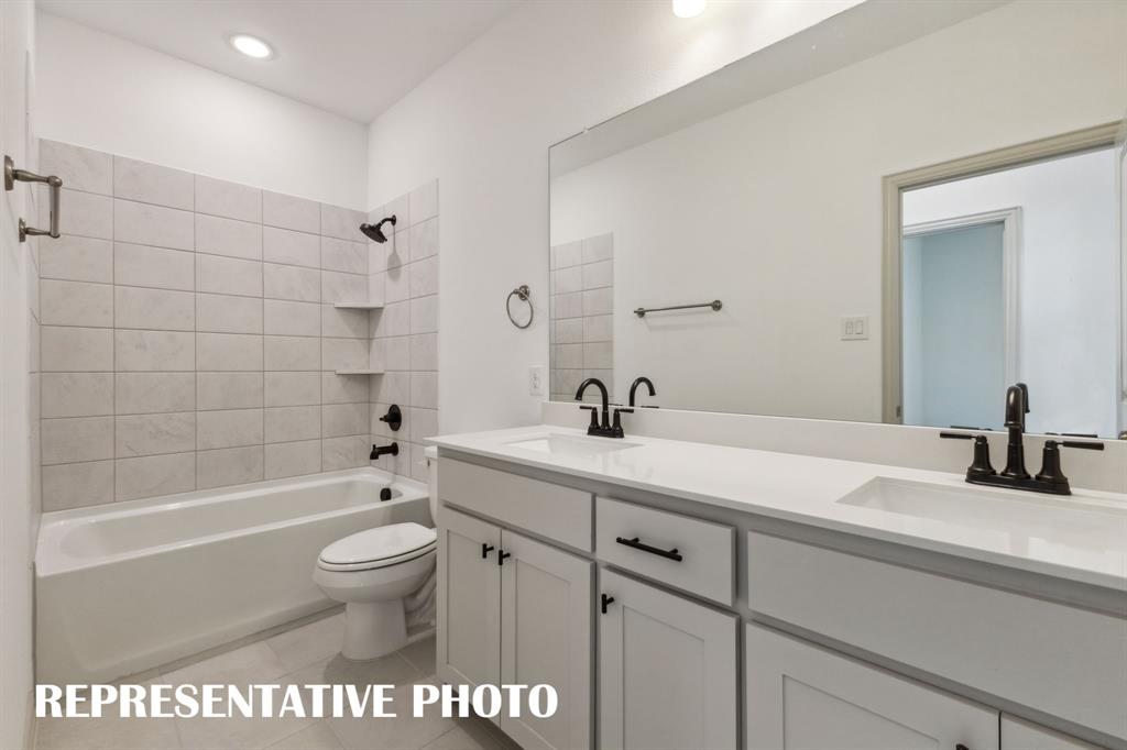 1009 Splitrock Drive Allen, TX 75013 - Photo 16 of 20 a bathroom with a sink a toilet and bathtub