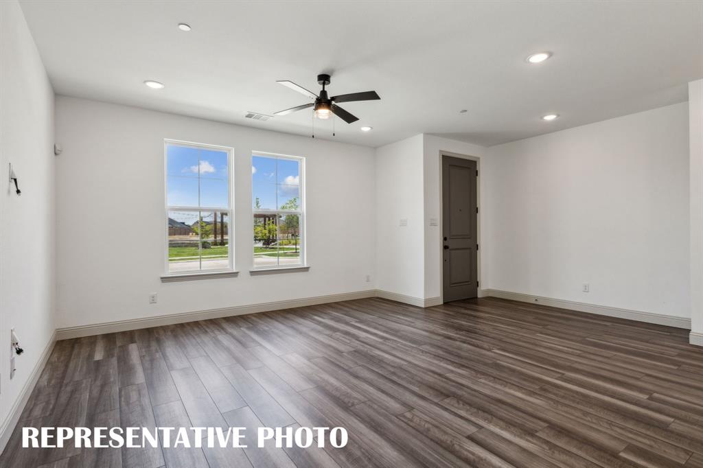 1009 Splitrock Drive Allen, TX 75013 - Photo 3 of 20 a view of an empty room with wooden floor and a window