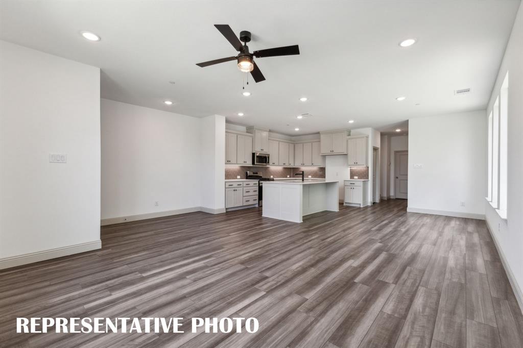 1009 Splitrock Drive Allen, TX 75013 - Photo 20 of 20 a view of a kitchen with a stove wooden floor and a ceiling fan