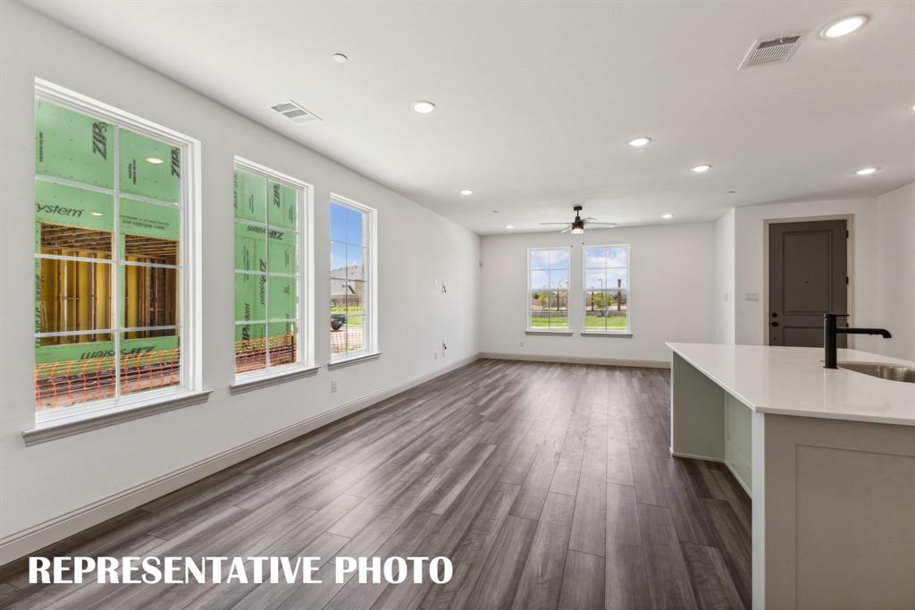 1009 Splitrock Drive Allen, TX 75013 - Photo 5 of 20 a view of an empty room with a window and wooden floor