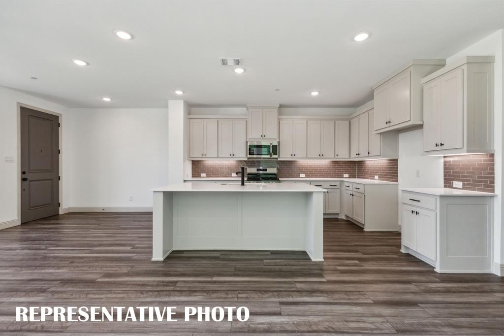 1009 Splitrock Drive Allen, TX 75013 - Photo 7 of 20 a kitchen with a sink stainless steel appliances and cabinets