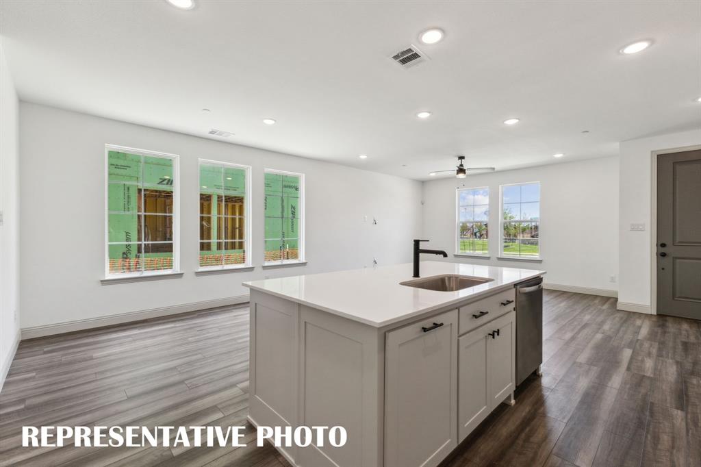 1009 Splitrock Drive Allen, TX 75013 - Photo 9 of 20 a kitchen with a sink and wooden floor